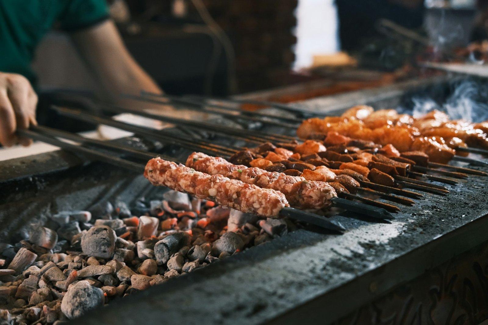Adana kebabs grilling over charcoal